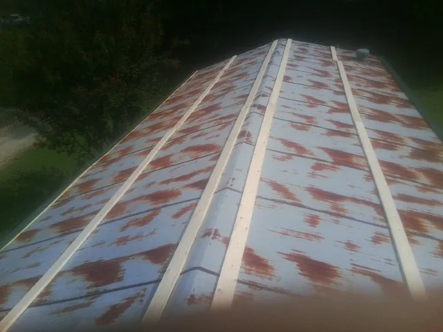 Rusted metal roof panels with new wood purlins before replacement — Storm Damage Roof Repair in Wanaque by Roofing Brothers