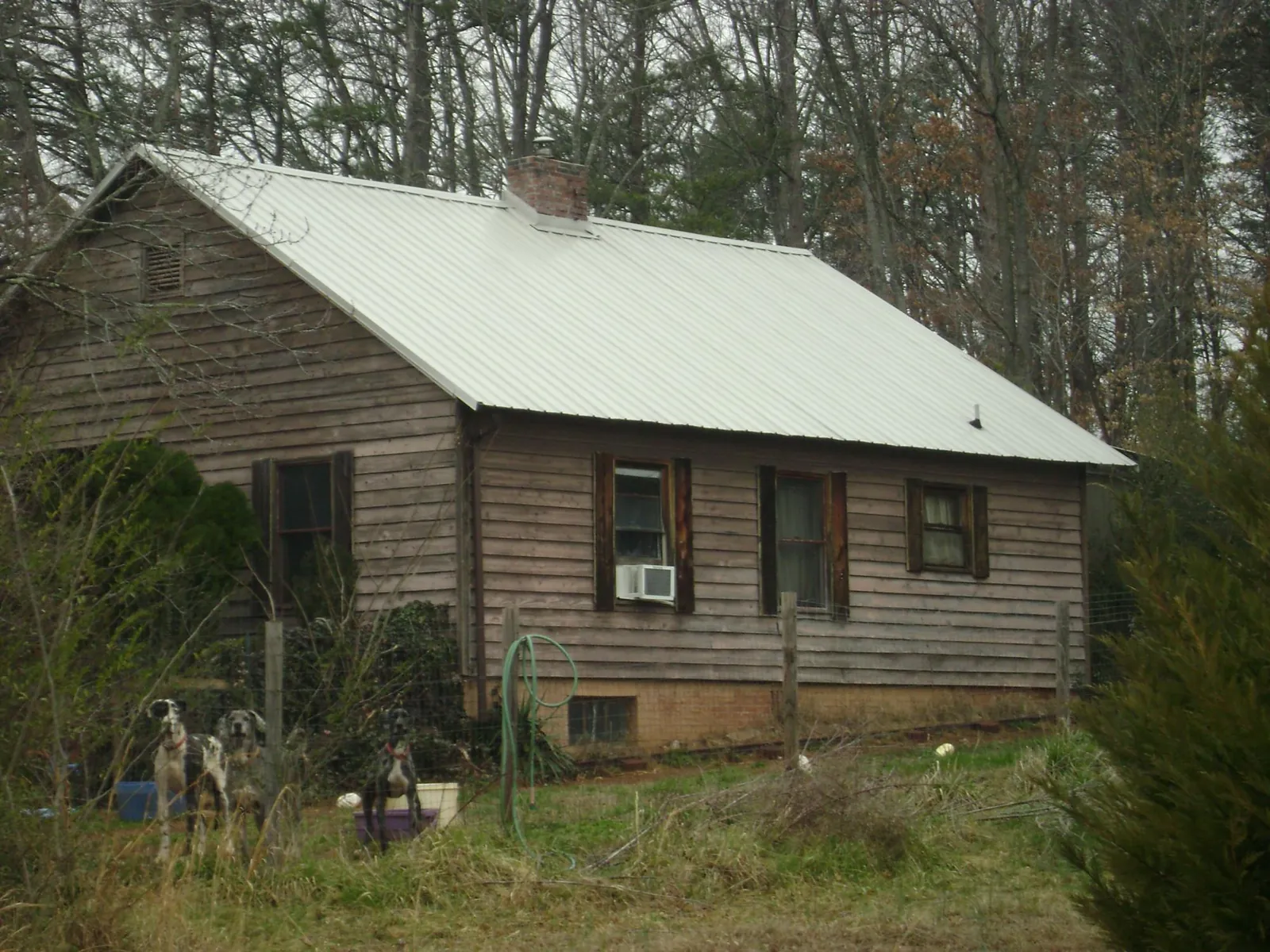 White metal roof on an old wood sided farmhouse, from a Metal Roof Installation job in Wanaque